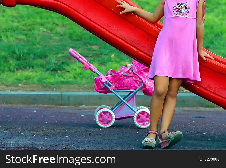 Young girl playing a mother at the playground. Young girl playing a mother at the playground