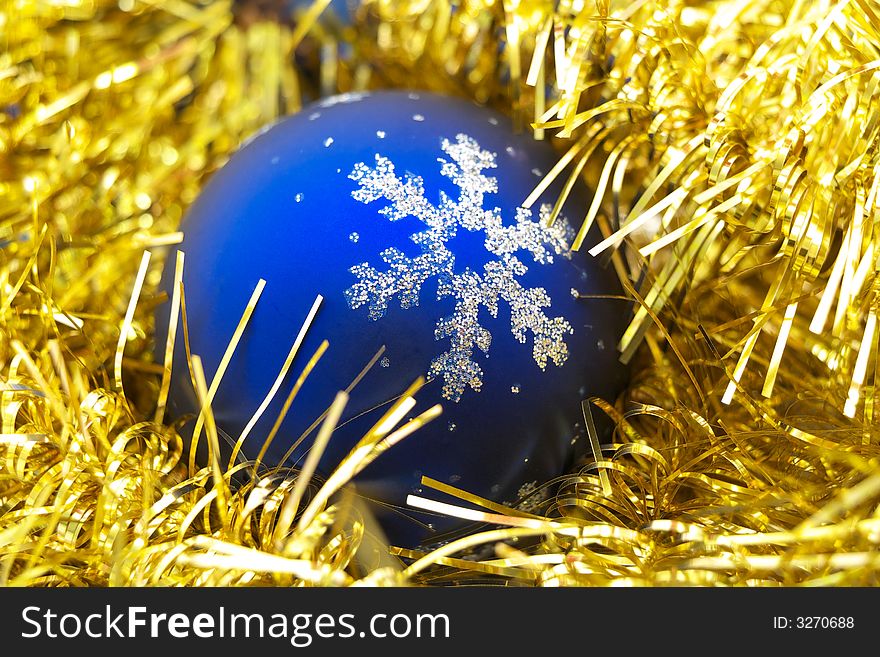 A cute, blue decoration christmas ball on yellow. A cute, blue decoration christmas ball on yellow