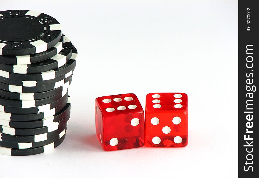 Two dice giving six beside a pile of black poker chips. Two dice giving six beside a pile of black poker chips