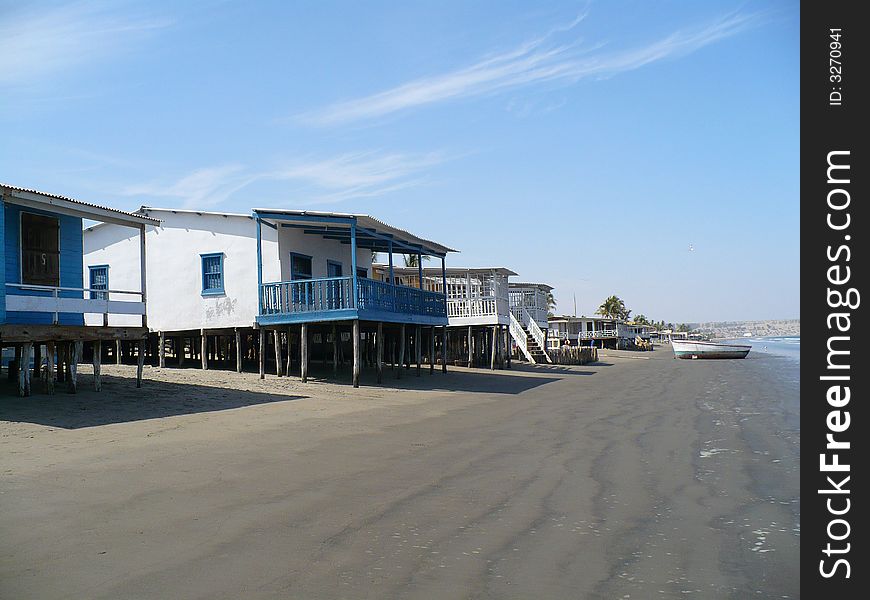 Beach-front houses, fishing boat outside. Beach-front houses, fishing boat outside