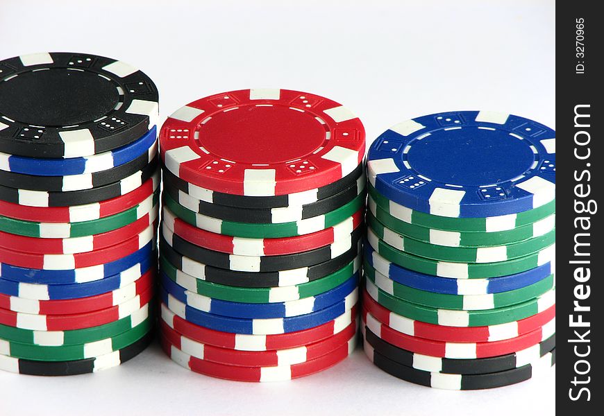 Three piles of poker chips of four different colors showing diversity. Three piles of poker chips of four different colors showing diversity