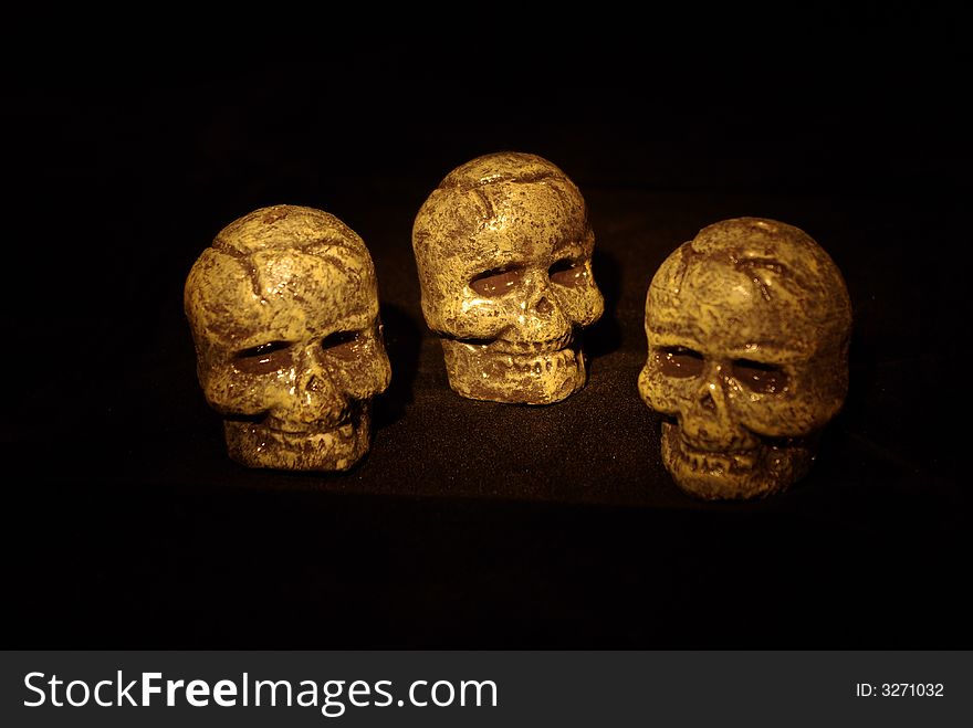 Halloween image - 3 dimly lit skulls isolated on black background. Halloween image - 3 dimly lit skulls isolated on black background