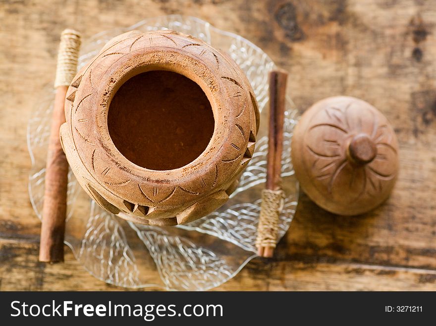 Traditional wood made chocolate powder container with cinnamon sticks. Traditional wood made chocolate powder container with cinnamon sticks