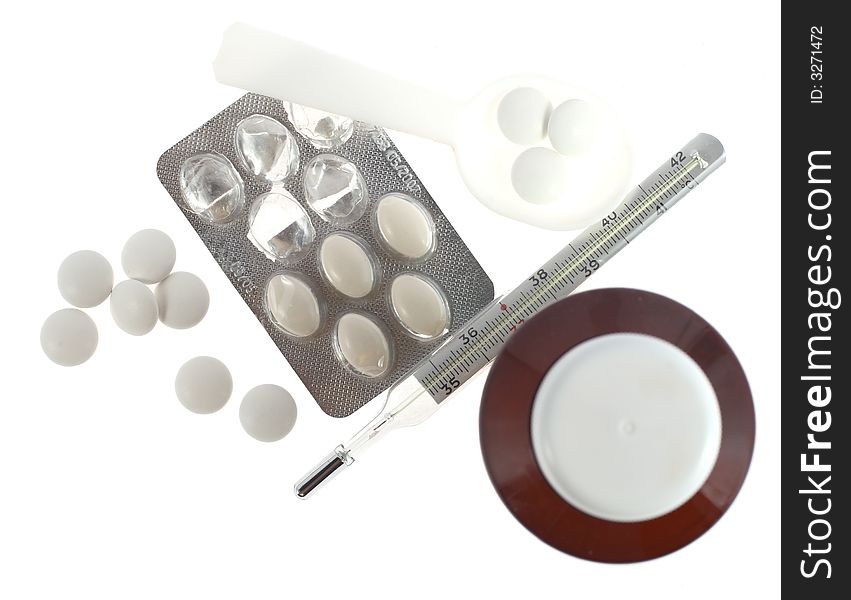 Medications pills, thermometer and other on white