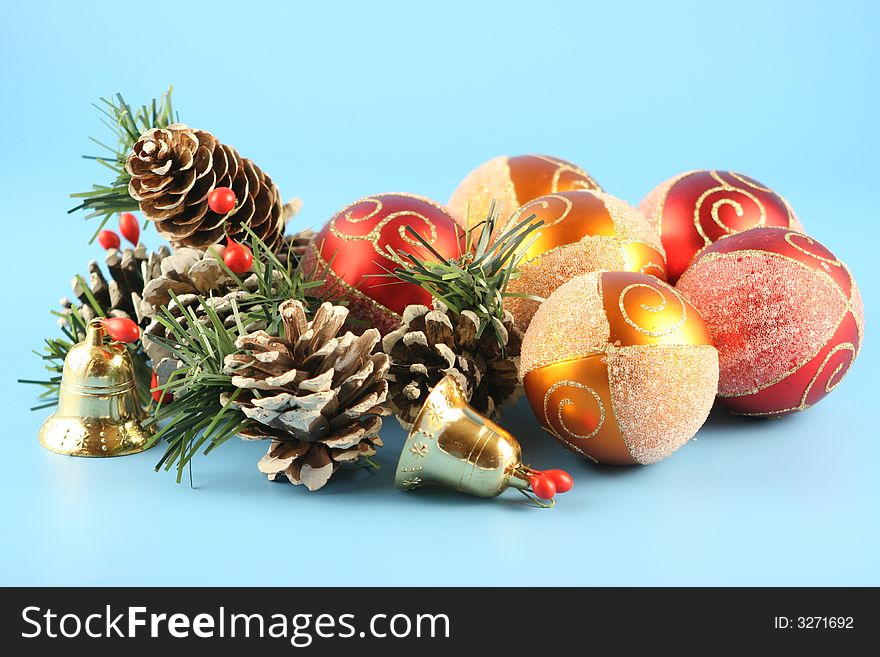 Christmas cones, balls and handbells on a blue background. Christmas cones, balls and handbells on a blue background.