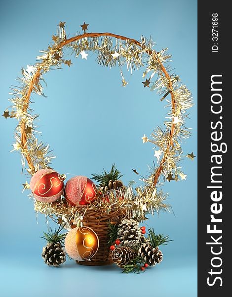 Basket with christmas balls on a blue background.