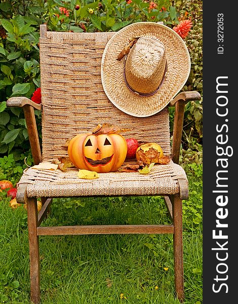Halloween pumpkin with straw hat, fruit and leaves. Halloween pumpkin with straw hat, fruit and leaves.