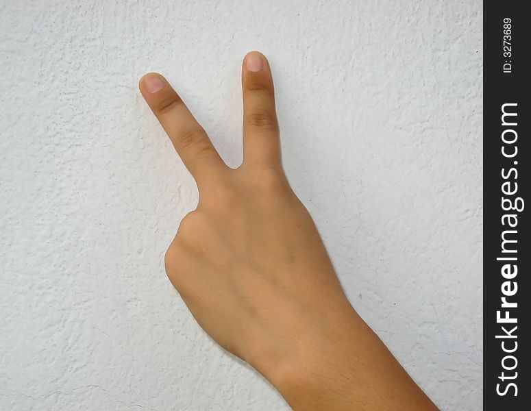 A female hand making the sign of victory