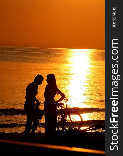 Couple at sunset in the sea,