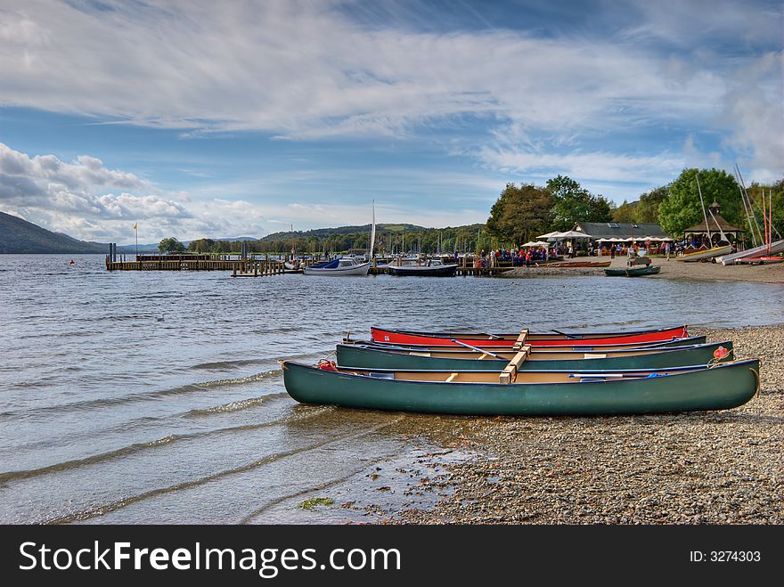 Canoes on the shore of Coniston Water in the English lake District. Canoes on the shore of Coniston Water in the English lake District