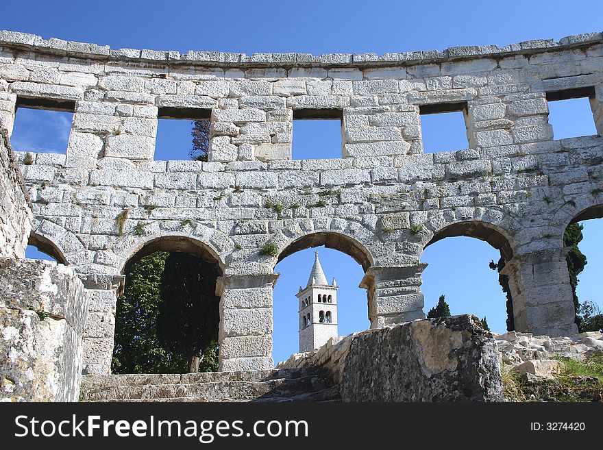 Belltower of the church of St. Anton. Seen from inside the amphitheatre in Pula, Croatia. Belltower of the church of St. Anton. Seen from inside the amphitheatre in Pula, Croatia