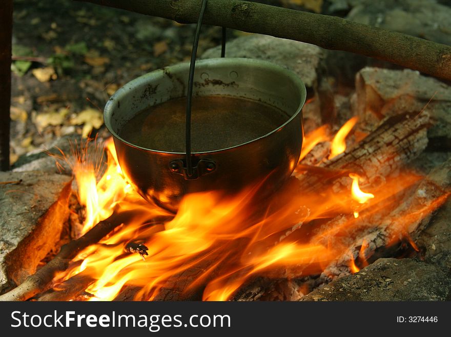 Saucepan on fire. Cooking in a wood