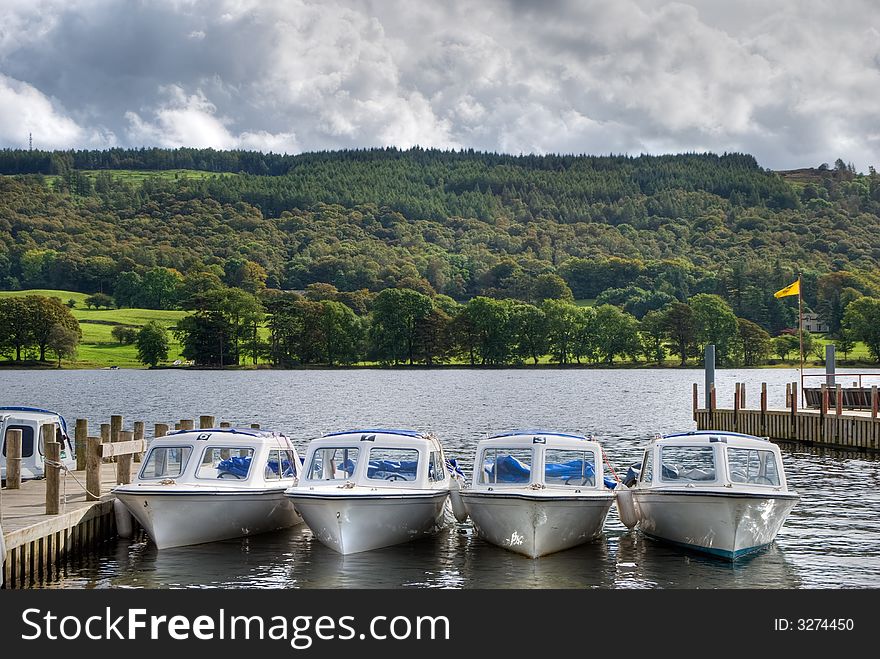Pleasure boats on the shore of Coniston Water in the English lake District