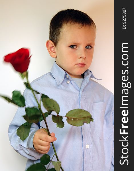 Adorable and shy 3 years old boy with flowers. Adorable and shy 3 years old boy with flowers