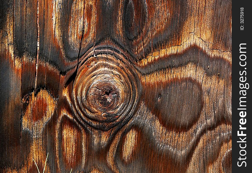 Pattern in a plywood panel with a large knot and unusual grain texture. Pattern in a plywood panel with a large knot and unusual grain texture.