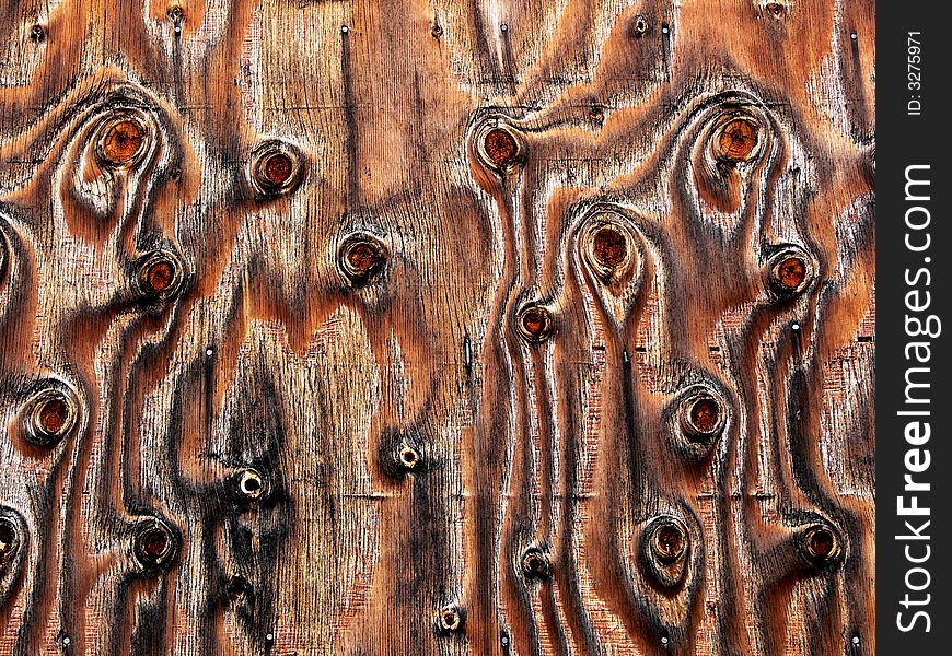 Shot of a plywood panel with knots and unusual wood grains and patterns. Shot of a plywood panel with knots and unusual wood grains and patterns.