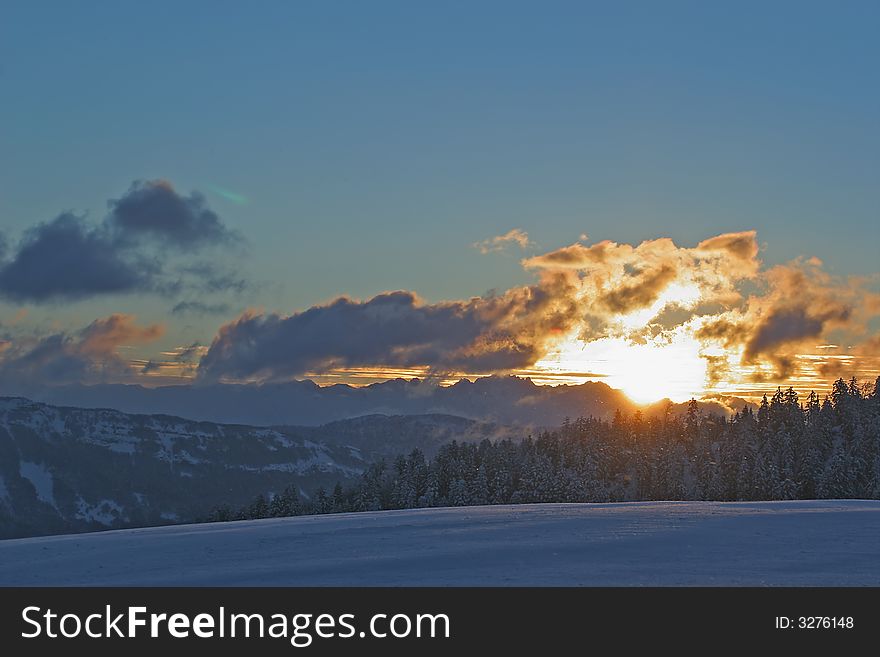 Landscape of mountain snow-covered at the sunset