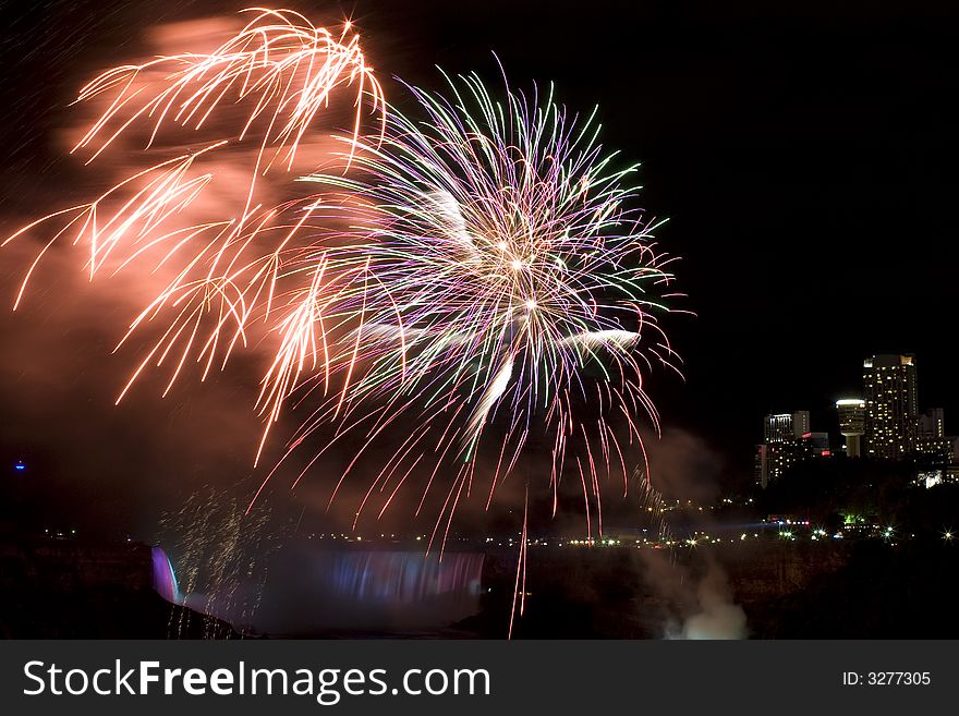 Colorful firework went off just above the waterfall. Colorful firework went off just above the waterfall