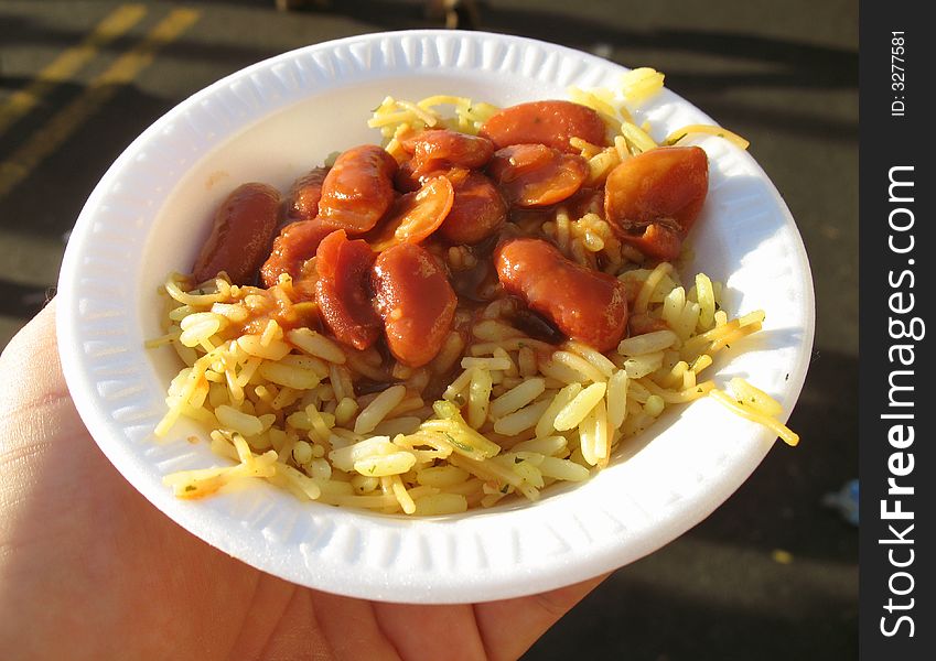 Photo of bean and rice sampler at a hispanic festival. Free samples of food are sometimes offered by manufacturers.