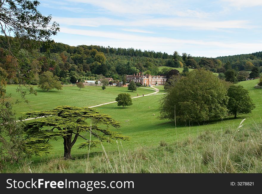 A Stately Home and Park in the rural English Countryside at the start of Autumn. A Stately Home and Park in the rural English Countryside at the start of Autumn