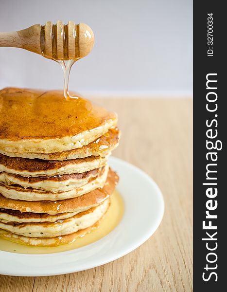 Stack of pancakes with honey