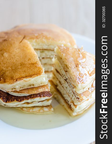 Stack of pancakes with fresh honey