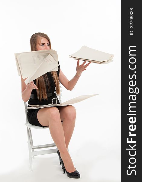 Young businesswoman disgruntled with what she read, throwing a pile of documents up in the air. Isolated on white. Young businesswoman disgruntled with what she read, throwing a pile of documents up in the air. Isolated on white