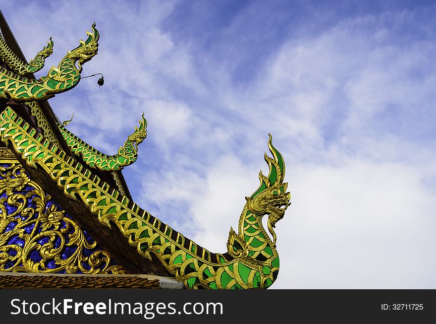 Traditional northern thai temple roof in blue sky