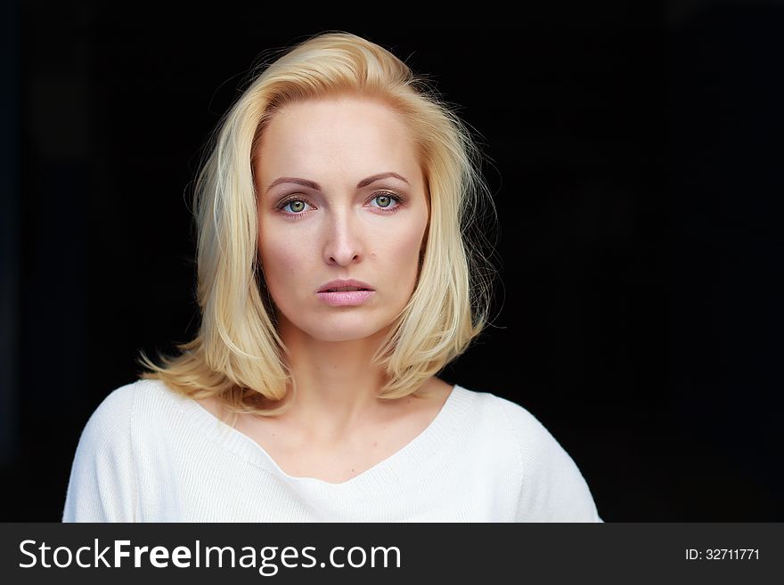 Portrait of a beautiful young glamour girl on a dark background. Portrait of a beautiful young glamour girl on a dark background