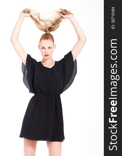 Beautifull young blond woman in the studio with a black dress. Beautifull young blond woman in the studio with a black dress