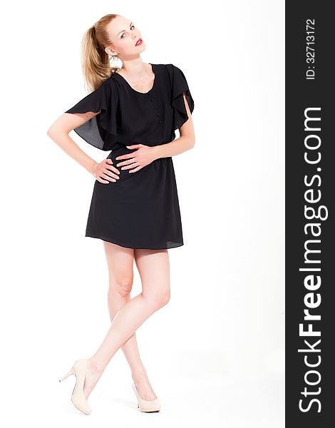 Beautifull young blond woman in the studio with a black dress. Beautifull young blond woman in the studio with a black dress