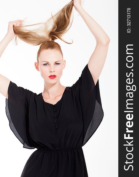 Beautifull young blond woman in the studio with a black dress. Beautifull young blond woman in the studio with a black dress