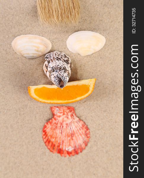 Mug made ??of shells, brush and orange slices on the sand. Mug made ??of shells, brush and orange slices on the sand