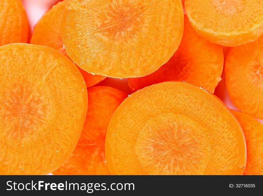 Raw Carrot Slices On A Whole Background