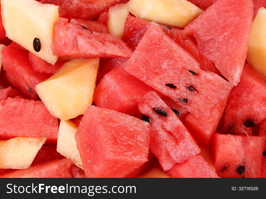 Bunch of sliced watermelons and melons close up.