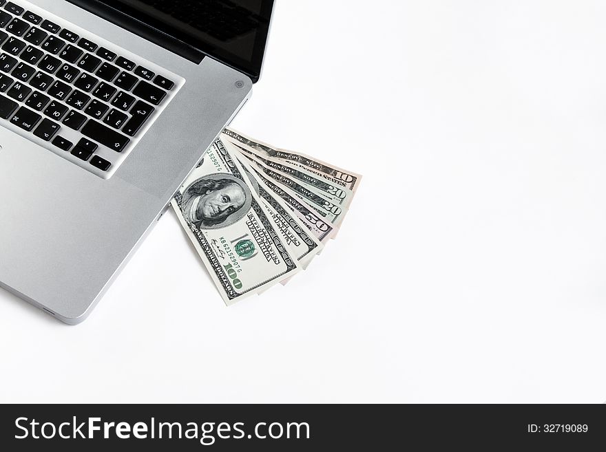 Laptop with money on white background. Laptop with money on white background