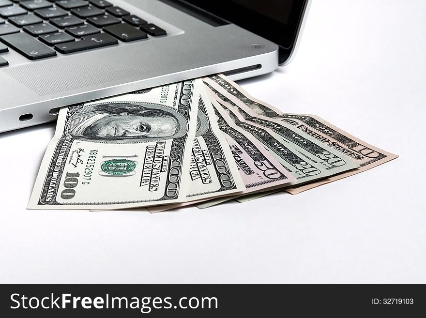 Laptop with money on white background. Laptop with money on white background