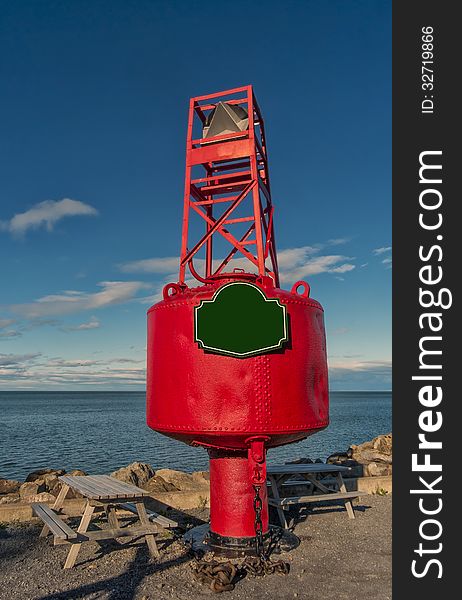 Starboard buoy in front of a quay. Starboard buoy in front of a quay