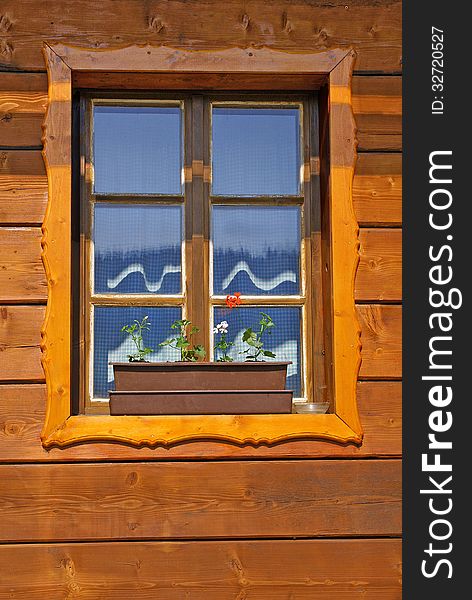 Window of wooden cottage close up