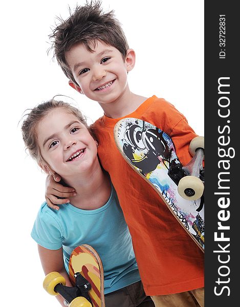 Photography of cute boy and girl are carring skate boards close up in studio shot. Photography of cute boy and girl are carring skate boards close up in studio shot