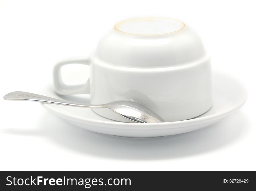 Empty coffee cup and spoon Isolated on white background