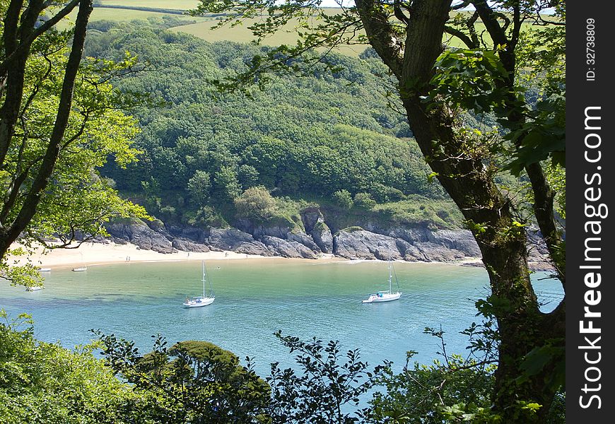 Wonderful rocky sandy cove with boats in scenic Devon. Wonderful rocky sandy cove with boats in scenic Devon.
