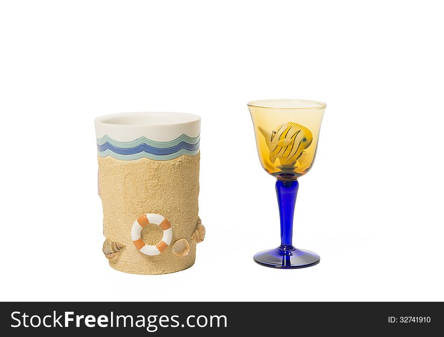 Fish In Wine Glass And Beach Cup Isolated On White Background