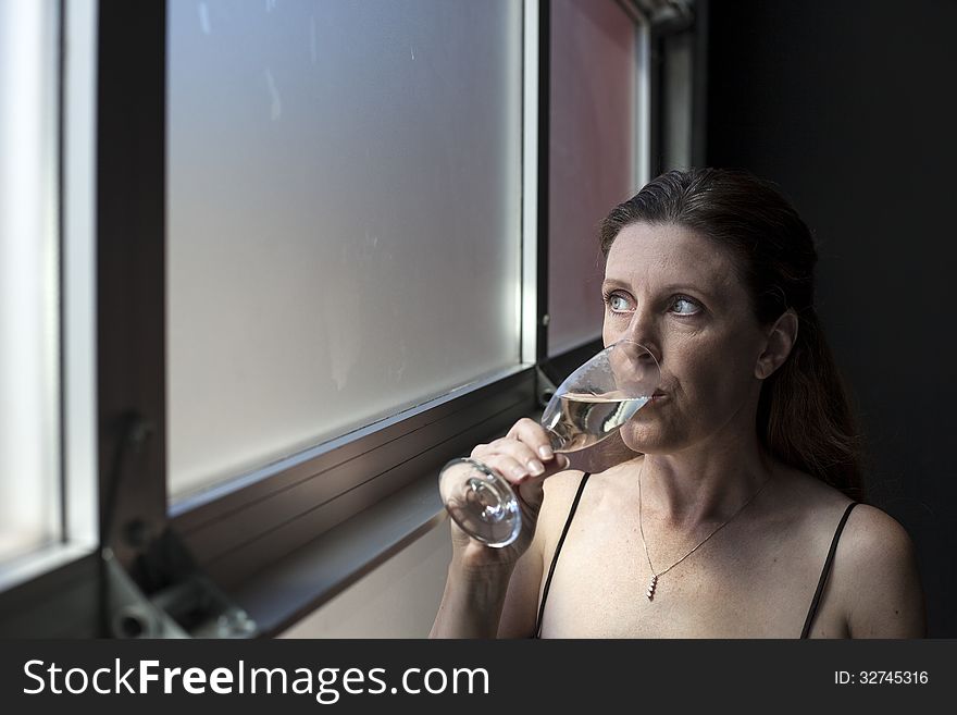 Middle Aged Woman In Black Dress With Champagne