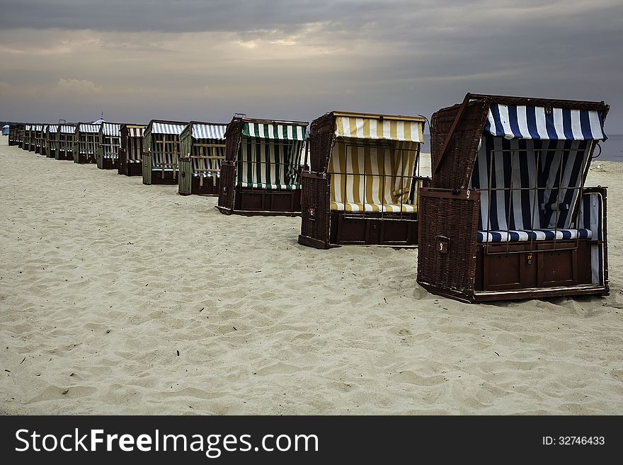 Wickerwork beach seats on the seashore against cloudy sky, Baltic Sea, Poland