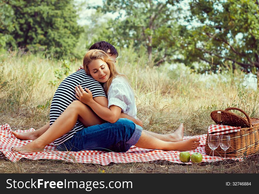 Beautiful couple have a rest in wood on picnic, sitting face to face closed eyes. Beautiful couple have a rest in wood on picnic, sitting face to face closed eyes