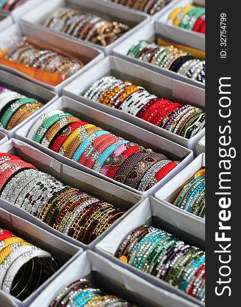 Collection of beautiful indian colorful bangles in vibrant colors. These pretty jewelry are made with beads and stones in vivid colors like red, blue, etc