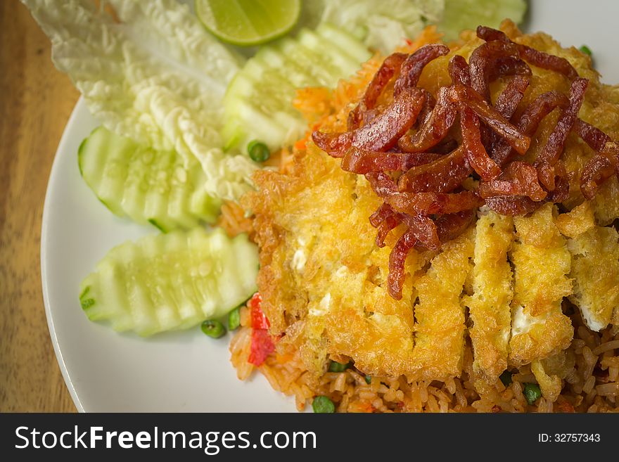 Fried rice with chili paste, omelet and deep fried pork on top