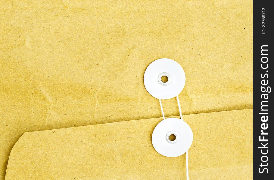 Close up of brown envelope and white string. Close up of brown envelope and white string