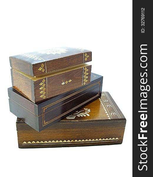 Wooden jewellery boxes/Three wooden jewellery boxes piled one on top on an other